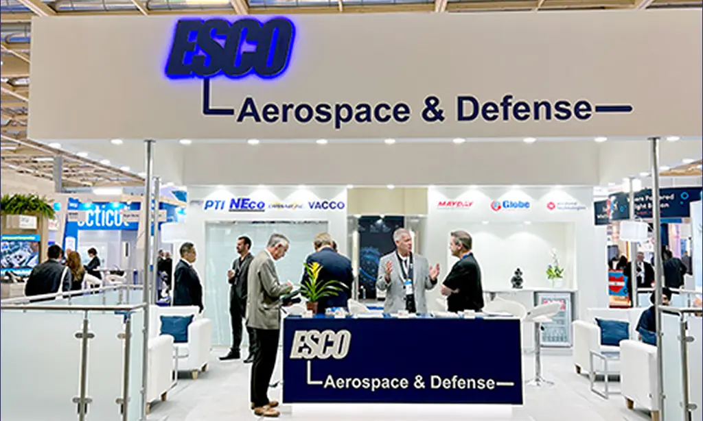 People standing around an aerospace and defense exhibit