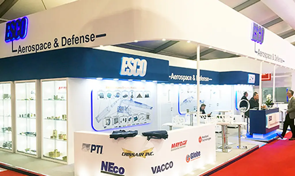 People standing around an aerospace and defense exhibit